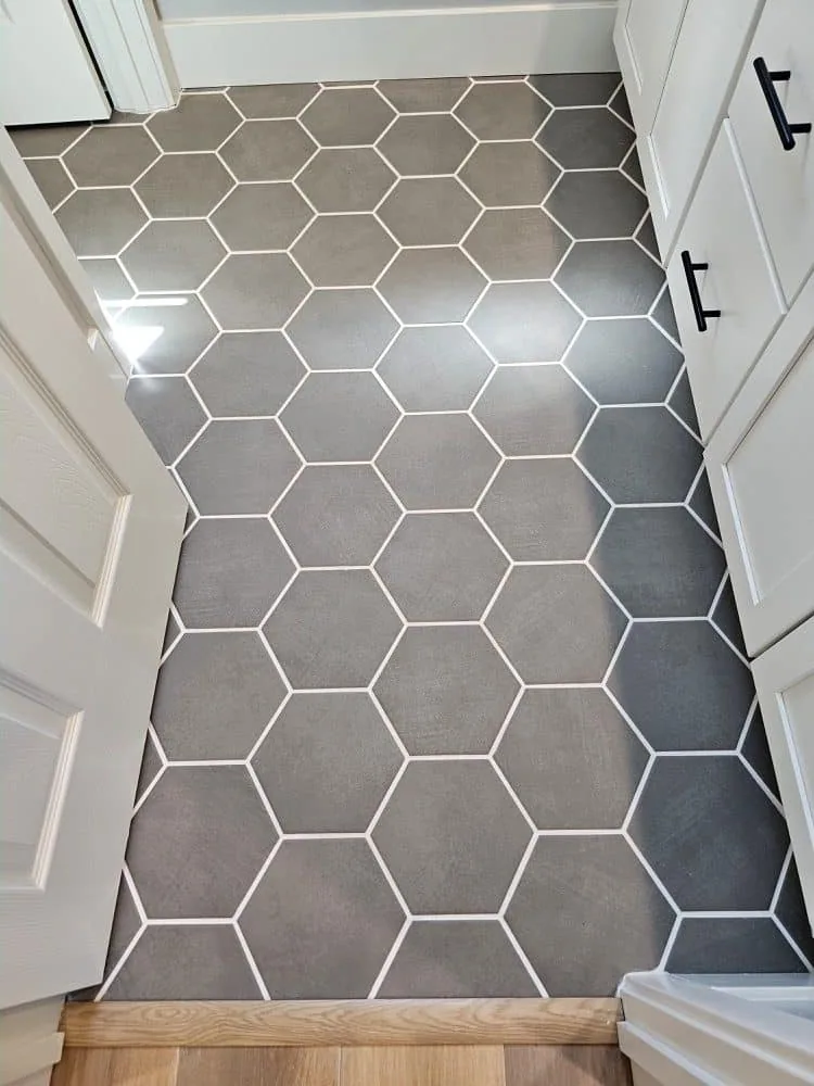 Dark hexagonal tile floor with light grout