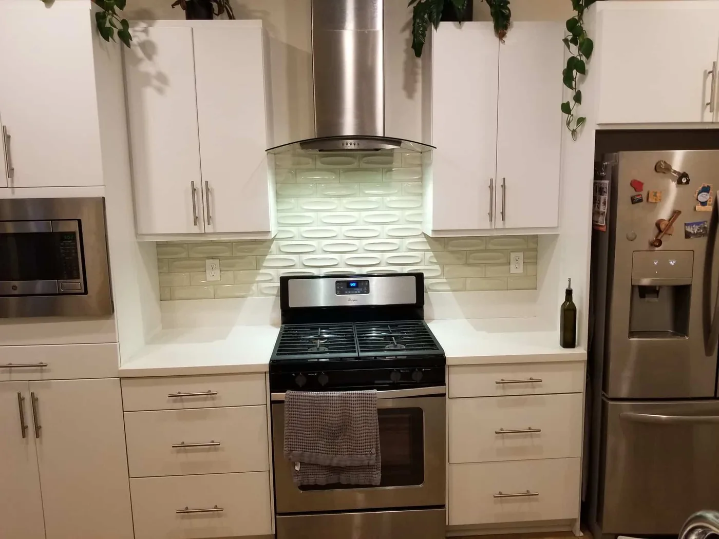Light tile backsplash in a finished white kitchen